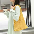 Vibrant yellow woven mesh shoulder bag with a beige drawstring inner pouch, SKU variant. - Yellow