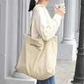 Beige corduroy shoulder bag with green letter embroidery for daily casual use. - Khaki