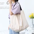 Minimalistische crèmekleurige nylon schoudertas met grote capaciteit voor reizen en dagelijks - Abrikoos