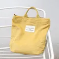 Stylish minimalist yellow corduroy tote bag with vintage French text patch design - Yellow