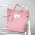 Vintage style pink corduroy tote bag with decorative letter patch and twin handles - Pink