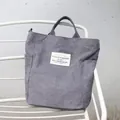 Vintage grey corduroy tote bag for students featuring a minimalist literary French label - Gray