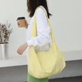 Minimalist yellow nylon crossbody bag with stylish crescent shape and comfortable strap - Yellow
