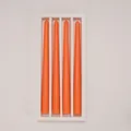 Top view of four long orange tapered candles neatly arranged in a white gift box - 4Pcs Set / Orange