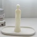Minimalist white male body silhouette candle placed on a decorative ceramic tray - Male Body / White
