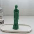 Artistic green male body shaped candle standing on a white minimalist display tray. - Male Body / Green