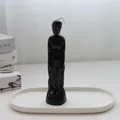 Artistic black feminine figure silhouette candle displayed on a white ceramic tray - Male Body / Black