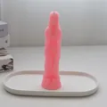 Elegant pink female body shape candle standing on a white minimalist decorative tray - Female Body / Pink