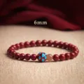 Elegant 6mm red cinnabar beaded bracelet featuring a vibrant blue lotus enamel charm detail - Purple Gold Cinnabar Artificial Enamel Style / 6mm