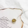 Minimalist silver chain bracelet featuring a round yellow rutilated quartz pendant - Rutilated Quartz Bracelet (White Gold Plated)