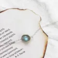 Minimalist silver chain bracelet featuring a glowing round iridescent moonstone charm - Moonstone Bracelet (White Gold Plated)