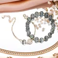Elegant green rutilated quartz bead bracelet with intricate hollow Tree of Life charm - Green Rutilated Quartz Set