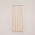 Detail view of four cream-colored long tapered candles in a white gift packaging box - 4Pcs Set / White