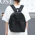 Minimalist black nylon drawstring backpack with pleated texture for casual use - Black