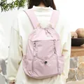 Stylish pink casual nylon backpack featuring drawstring closure and a pleated design texture - Pink