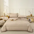 Cozy brown and white checkered cotton summer quilt bedding set in a bedroom setting - Coffee Small Check