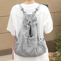 Lightweight grey nylon drawstring backpack with pleated texture and mesh pockets. - Gray