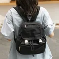 Casual black Japanese style canvas backpack with silver buckles and flap closure. - Black