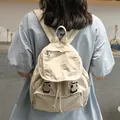 Casual vintage canvas backpack in beige worn by a model in a lifestyle setting. - Apricot