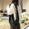 Large black denim dumpling hobo bag with a stylish knot shoulder strap, casual style. - Black