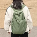 Stylish green pleated nylon backpack with a drawstring front pocket and carabiner detail - Green