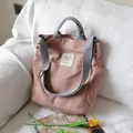 Pink canvas tote bag with adjustable grey shoulder strap and side pocket - Pink