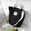 Stylish black canvas tote bag with cream-colored straps, versatile for daily use - Black