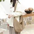 Minimalist khaki corduroy crossbody bag with adjustable knot shoulder strap design. - Camel