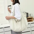 Large cream canvas tote bag with bold letter print for casual daily use - Apricot