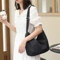 Casual black pleated nylon crossbody bag for women featuring an adjustable shoulder strap - Black