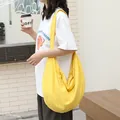 Casual yellow popcorn bubble texture hobo bag worn by a model in an outdoor setting - Dumpling Bag Style / Yellow