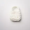 Gedetailleerd overzicht van handgemaakte witte mini-tas van zacht chenille garen - Crèmewit