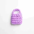 Primer plano detallado que muestra la textura suave de un bolso de punto morado - Morado Loto