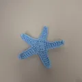 Macro view van een lichtblauw handgemaakte gehaakte zeester tas accessoire textuur - Blauwe Zeester