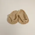 High-quality detail of handmade crochet baby flip-flops for newborn photography props - Khaki