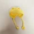 Close-up of a handmade yellow crocheted mini hat with braided ties for doll accessories - Light Yellow