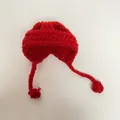 Detail view of handmade red crochet mini hat with straps for dolls and small pets - Red