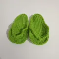 Detailed view of hand-crocheted green baby flip-flops for newborn photography - Sprout Green