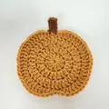 Handmade crocheted pumpkin coaster in orange yarn for rustic Halloween and Autumn table decor - Gold