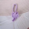 Detailweergave van een paars gehaakte pluche sleutelhanger met een klavertje vier - Lichtpaars