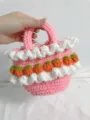 Close-up of pink crochet tote bag featuring white ruffles and small strawberry details - Finished Product / Light Pink