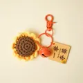 Handgemaakte gehaakte zonnebloem sleutelhanger met een oranje belletje en label - Zonnebloem Stijl