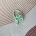 Detail van een handgemaakte groene gehaakte klavertjevier hanger met ophanglus - Watergroen