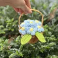 Handmade knitted blue puffy flower basket ornament in a miniature woven basket. - Puff Flower Basket / Blue