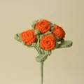 Detailed view of a handmade orange crochet rose bouquet with four flower heads - Orange