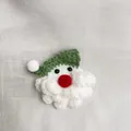 Handmade crochet Santa Claus brooch decoration featuring a green hat and fluffy beard - Green Santa Claus Brooch