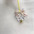Exquisite handmade white crochet Christmas ornament featuring a gold bell and ribbon decoration - Peace and Joy Pendant No. 1 / White