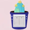Detail view of a cute cartoon cactus silicone switch cover on a double rocker switch - Hamalocactus Setispinus / 8.6x8.6cm