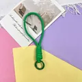 Macro detail view of the vibrant green braided phone wrist lanyard and attachment ring - Phone Cord / 1 Piece / Green