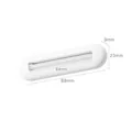 Manual white toothpaste squeezer tool with dimensions 89mm x 23mm shown in detail - White
